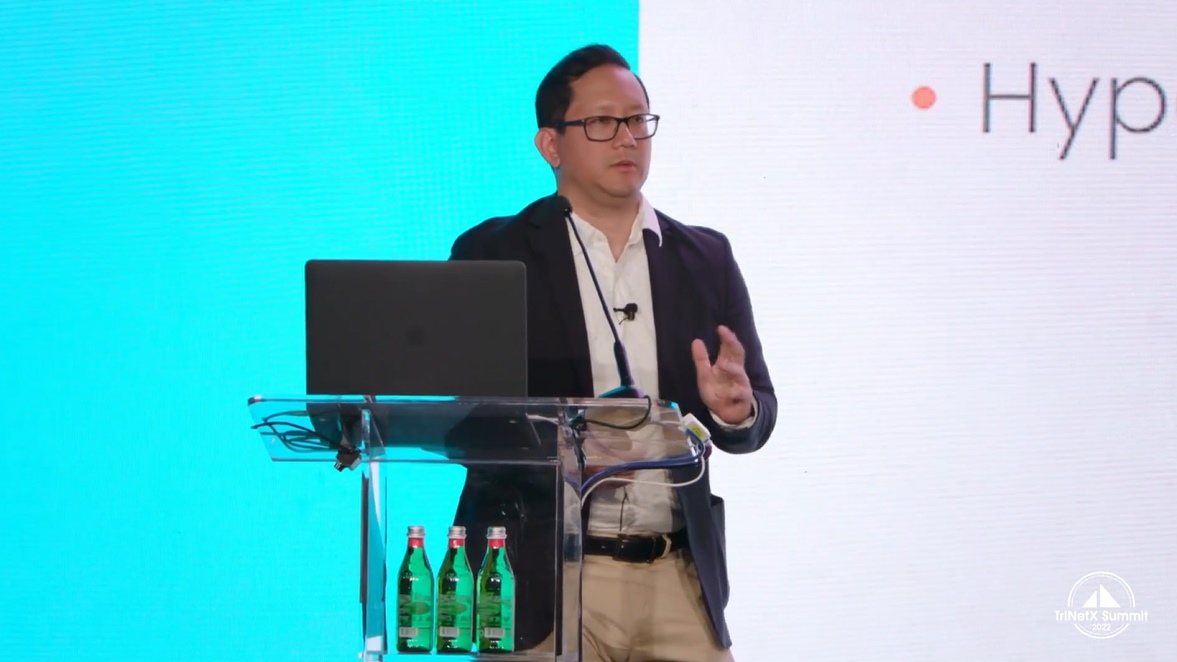Dr Daniel Liu presenting on stage at TriNetX Summit 2022