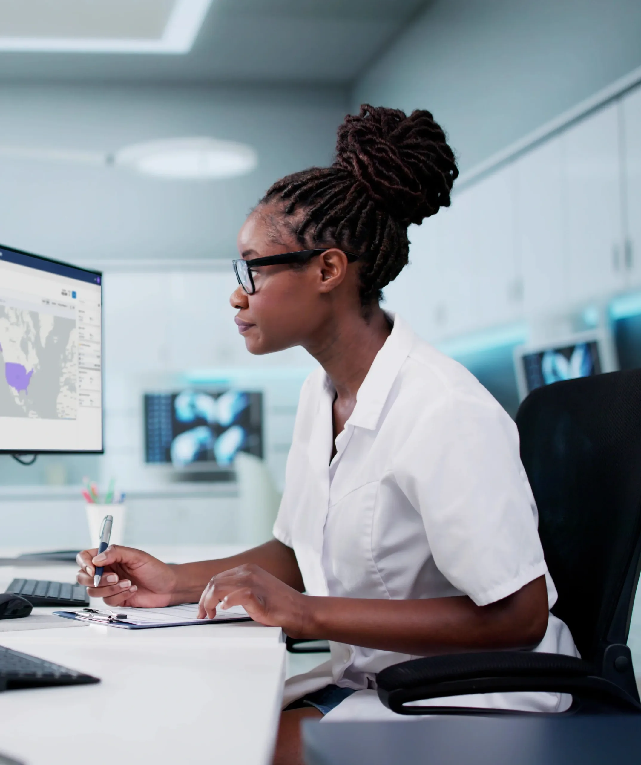 Lady working in an office behind a laptop