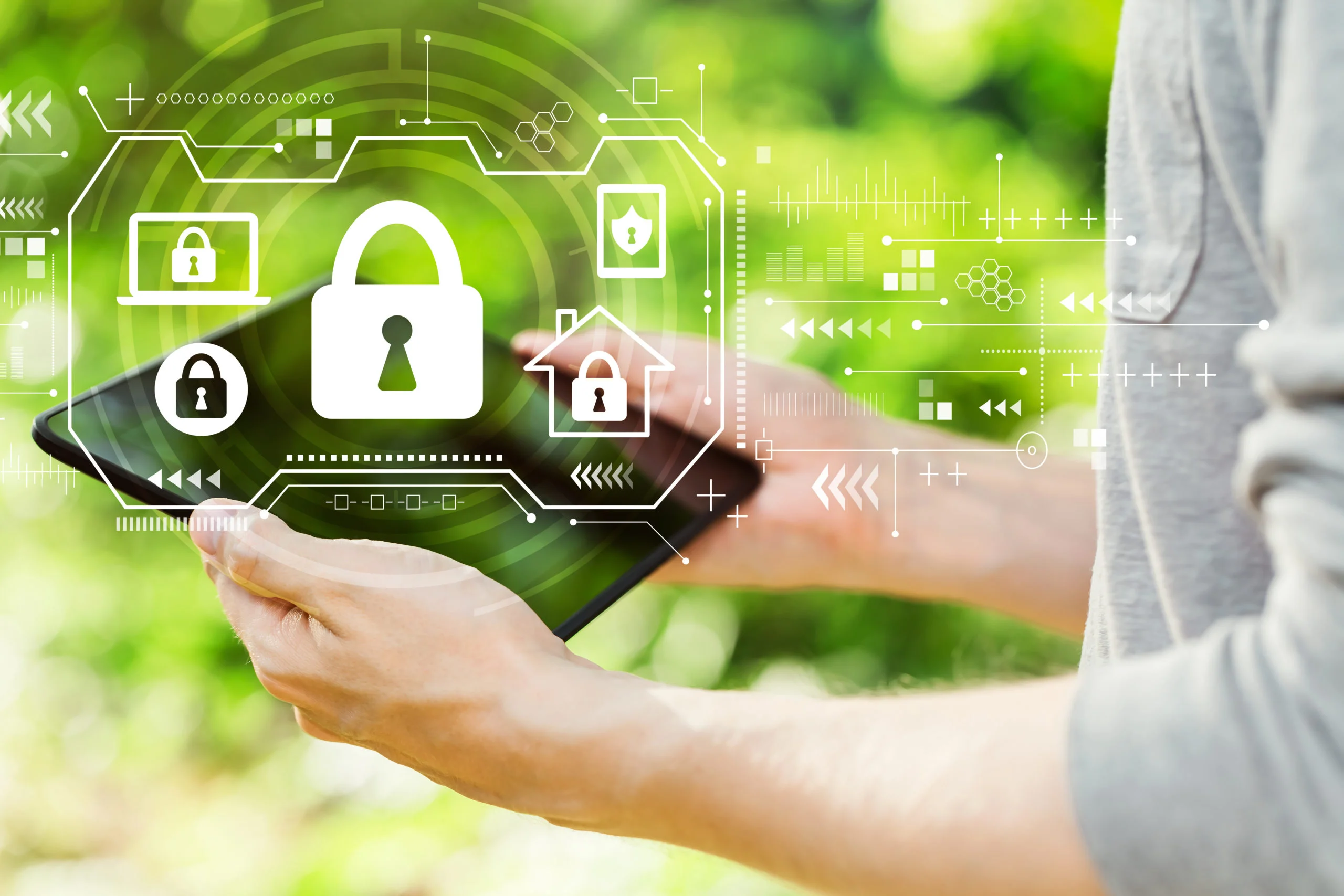 Security theme with young man holding his tablet computer outside